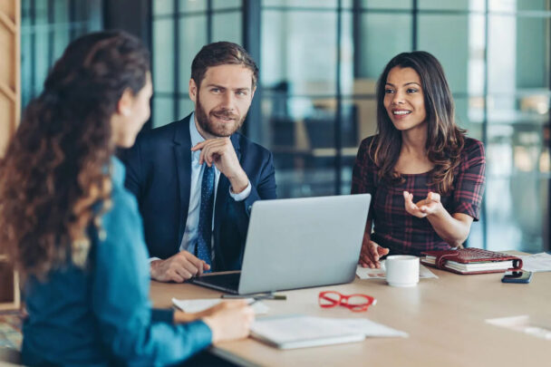 A male executive having a conversation on a laptop.